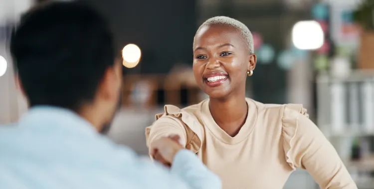 Shaking hands, professional team and smile, partnership and collaboration, agreement or deal with success. Diversity, handshake and people happy working together in meeting with teamwork and trust 